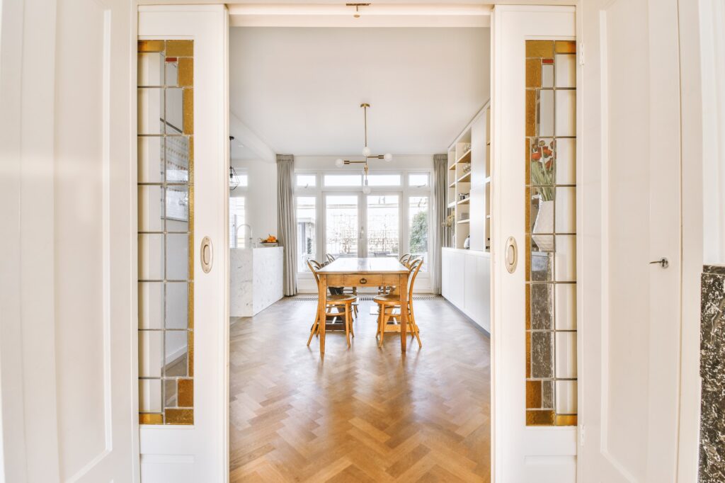 Empty dining room near open kitchen