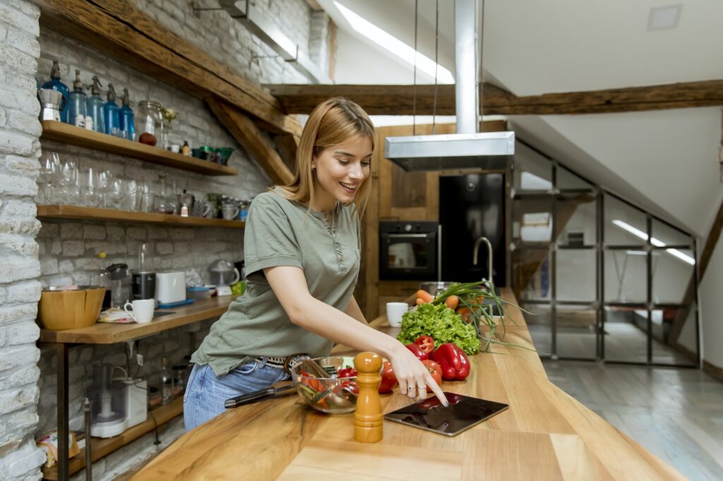 Young woman preparing food in the rustic kitchen